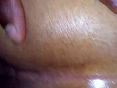 Oiled booty teases beautifully