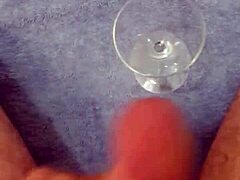 Solo cumshot captured in a glass after intense stroking