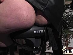 Strap-on dildo dominates on the wheel