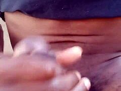 Moaning while stroking big black cock outdoors