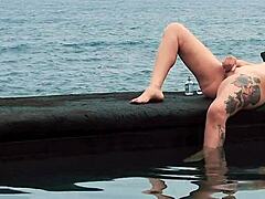 Tattooed vixen enjoys solo sea session