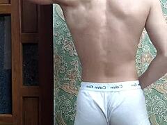 Skinny boy flexes his muscular body in underwear at home