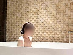 cute asian brunette enjoys solo bath time at luxury hotel with fetish vibes