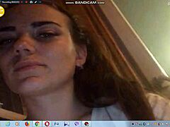 Sexy young brunette with big tits teases by showing boobs on webcam