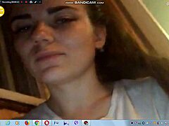 Sexy young brunette with big tits teases by showing boobs on webcam