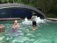 Young lesbian teens casually explore each other's wet pussies while splashing around the sunny swimming pool in a playful outdoor session.