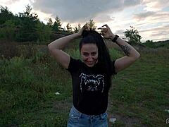 Black Lynn ties long black hair into ponytail for intense blowjob on huge cock outdoors