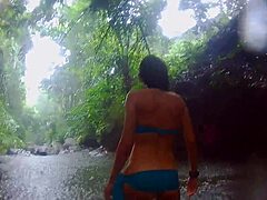 Exotic couple with muscular bodybuilder husband and skinny girlfriend with small tits and long hair fuck passionately in tropical jungle rain, reaching wet orgasm amid nature and forest with ass shaking.