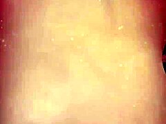 Japanese milf in blue satin lingerie shows off big tits during solo webcam striptease with asian details.