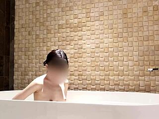 cute asian brunette enjoys solo bath time at luxury hotel with fetish vibes