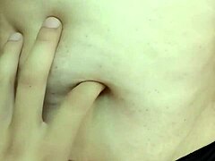 The guy indulges in exploring the curvy milf's navel during an intimate belly massage.