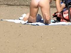 Pink princess struts on the beach with hidden candid vibes, contrasting her ass against the waves in intriguing princess style.