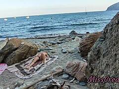 She flashes her pussy at a guy on the public beach. He helps her squirt in this risky hidden cam moment.