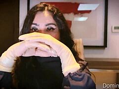 nurse snaps on latex gloves for patient's asmr checkup