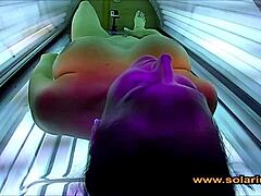 Beautiful solarium woman fingers pussy on cam